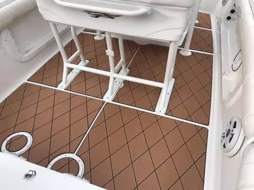 White marine toilet and plumbing on a brown tiled boat floor, with white rails and fittings nearby