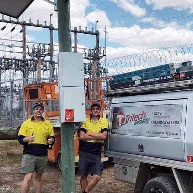 Two workers posing for the camera — Security Systems in Armidale, NSW