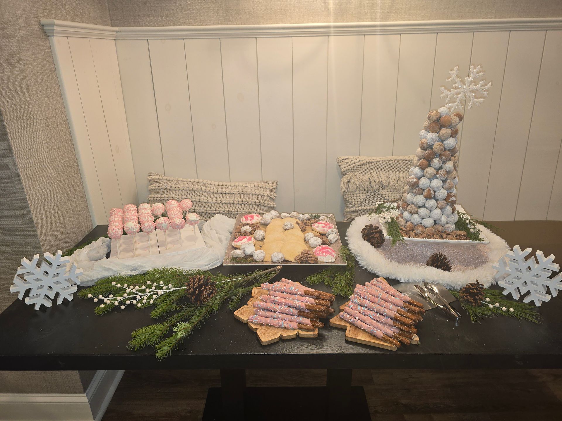 Dessert buffet with pastel pastries, cookies, and a tall marshmallow cone centerpiece on a black table
