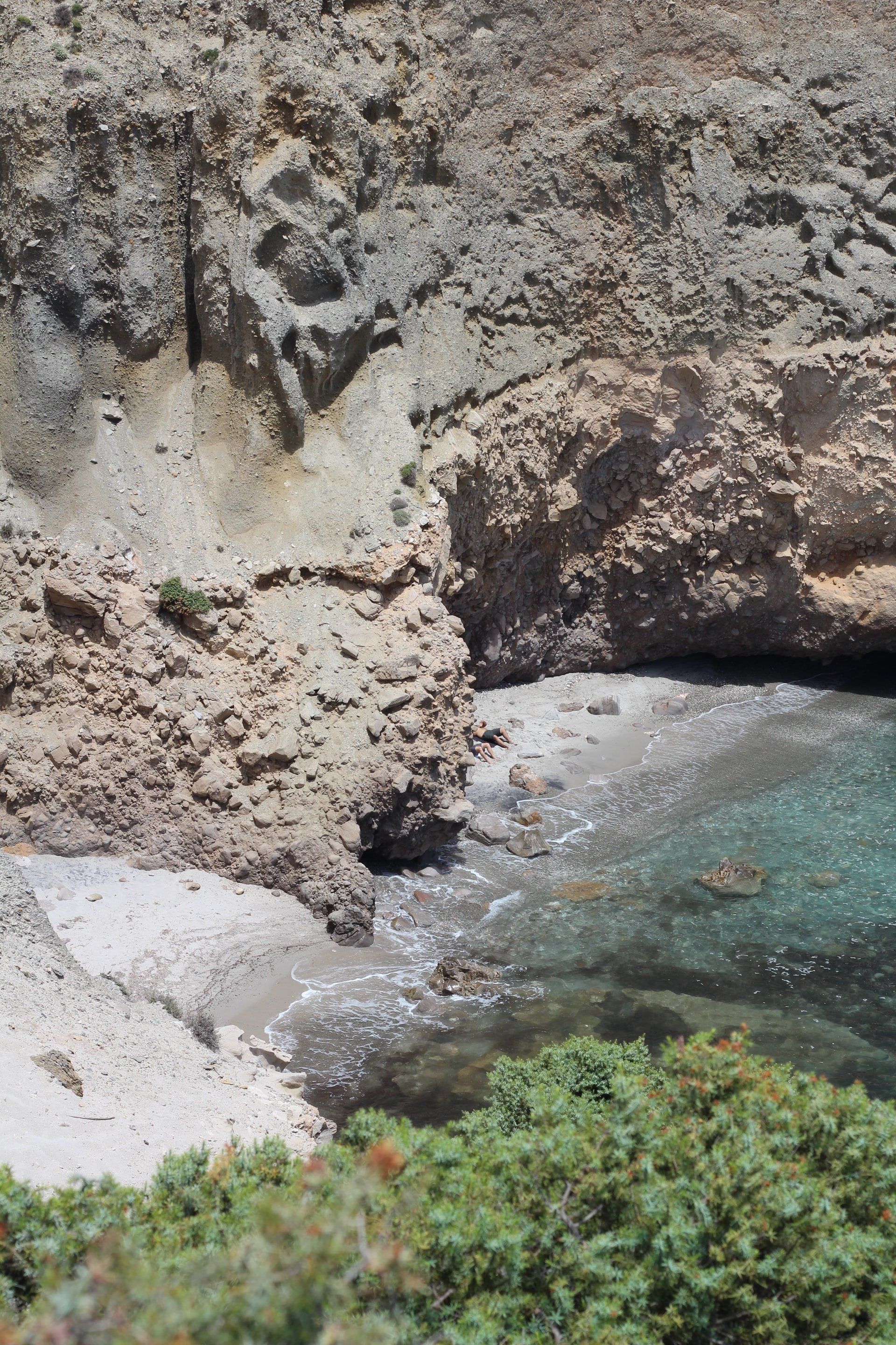 A small body of water surrounded by rocks and trees