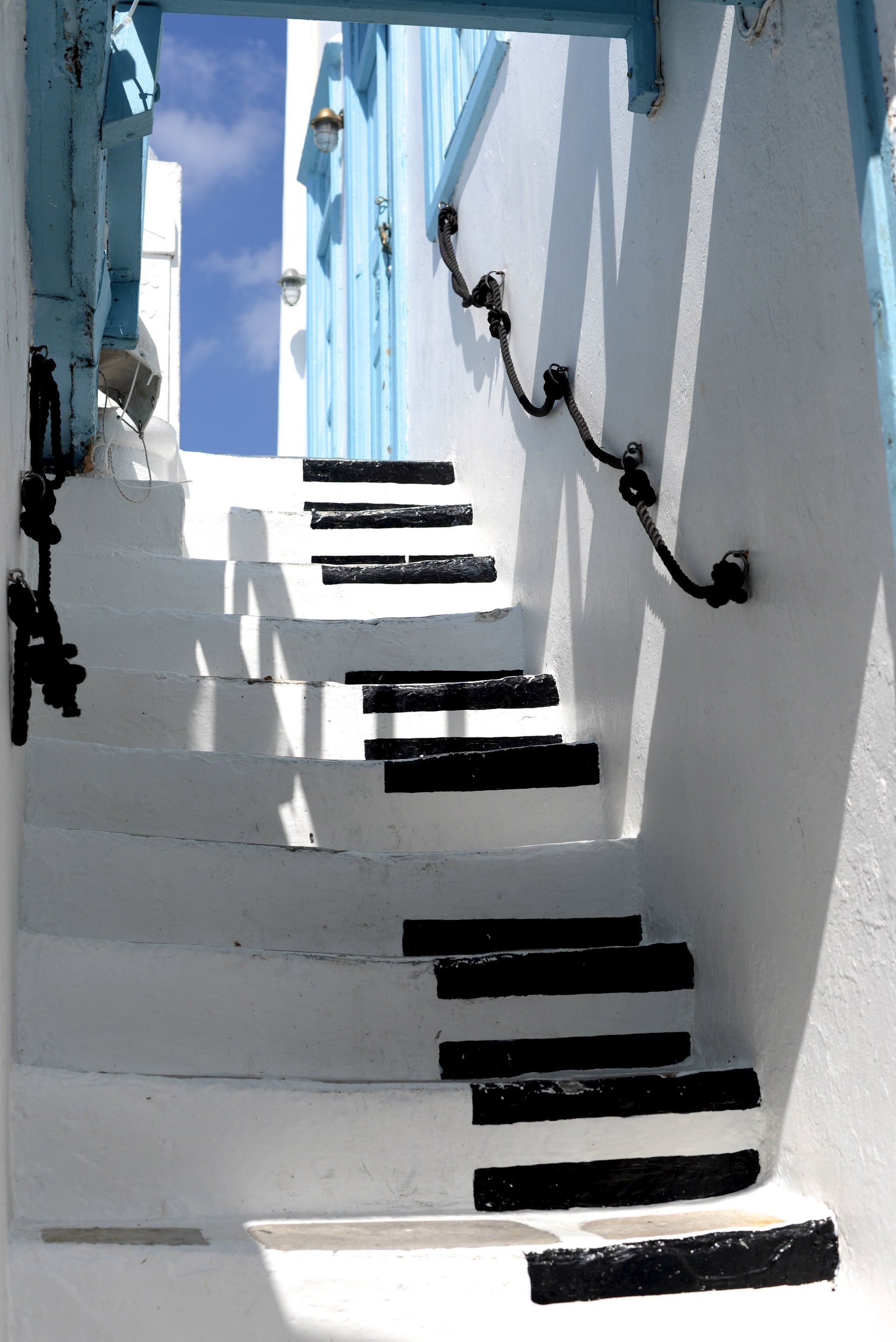 A set of stairs leading up to a blue door
