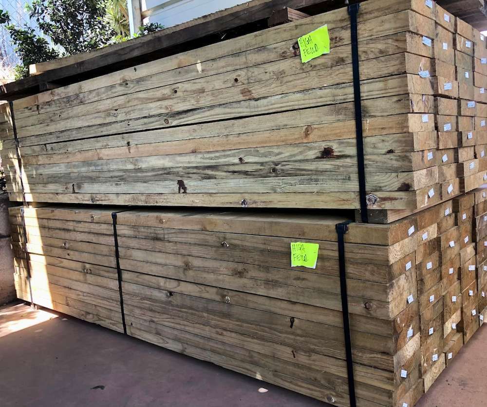 A Stack of Wooden Beams Sitting on Top of Each Other — Highfields Landscape Supplies In Meringandan, QLD
