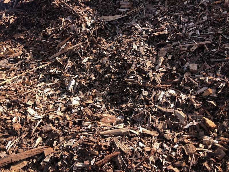 A Pile of Wood Chips is Laying on the Ground — Highfields Landscape Supplies In Meringandan, QLD