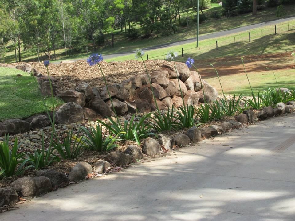 A Row of Rocks and Plants Along the Side of a Road — Highfields Landscape Supplies In Meringandan, QLD