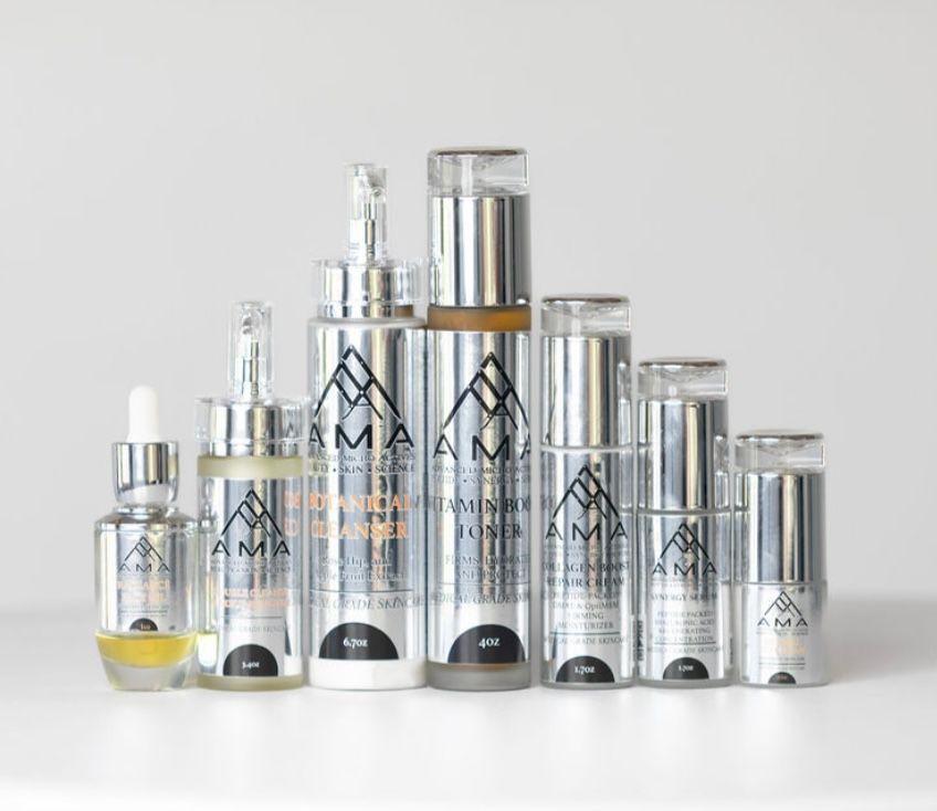 Skincare product bottles with silver and black labeling against a white background.