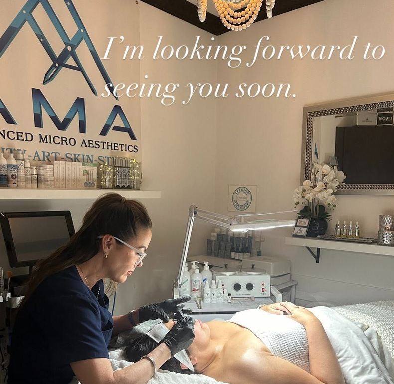 Woman receiving a luxurious facial treatment in soft warm light