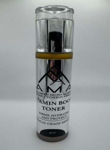 A silver AMA Vitamin Boost Toner bottle with clear cap and gold band.