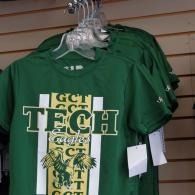 Green GCT Tech T-shirts on hangers displayed in a store, with white and gold lettering.