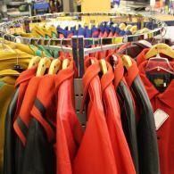 Red and black jackets hanging on a circular clothing rack in a store