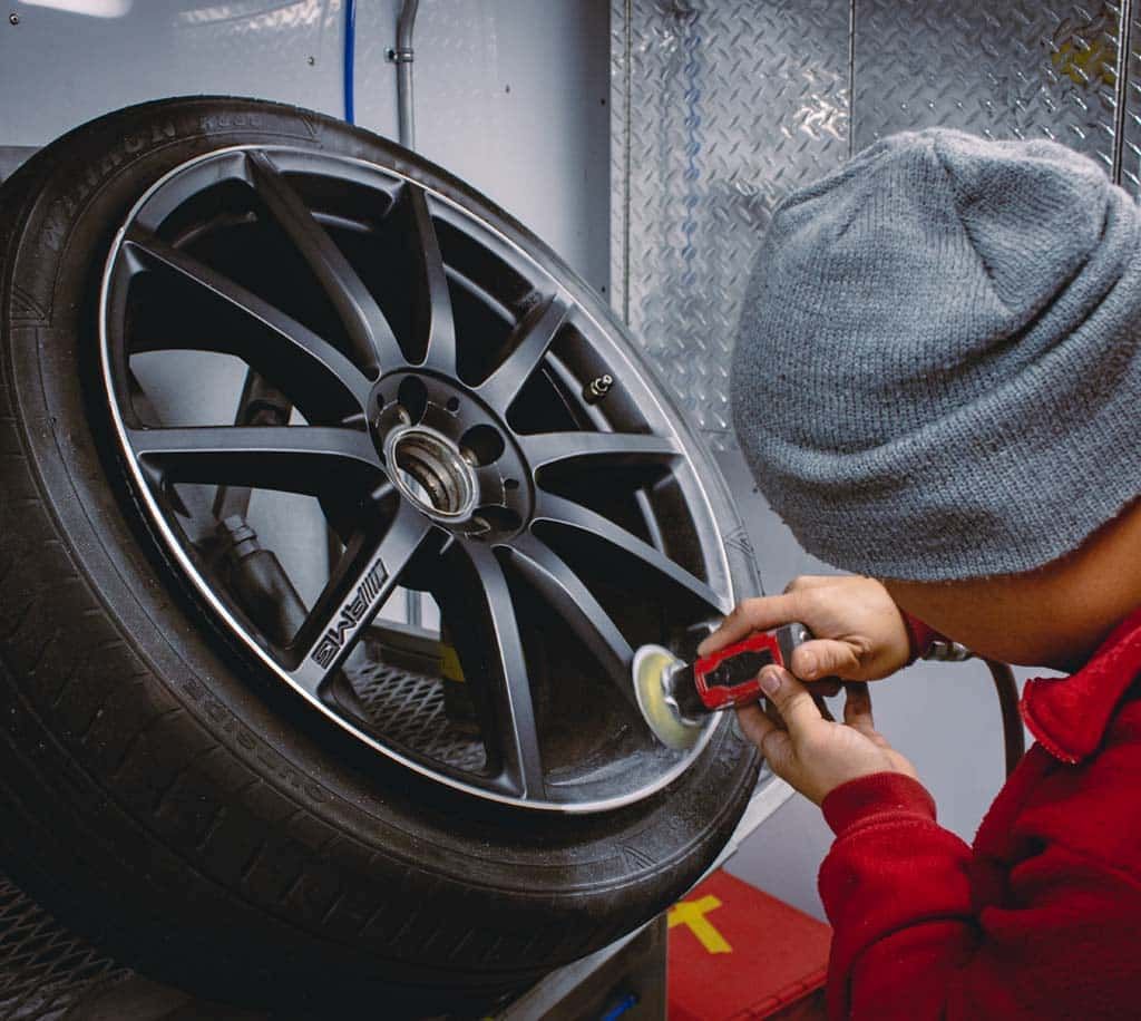 Expert technician restoring an alloy wheel with precision finishing at Uncle J's Tire & Rim