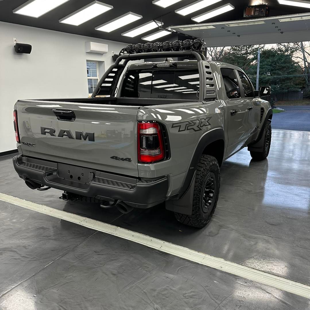 A gray ram truck is parked in a garage.