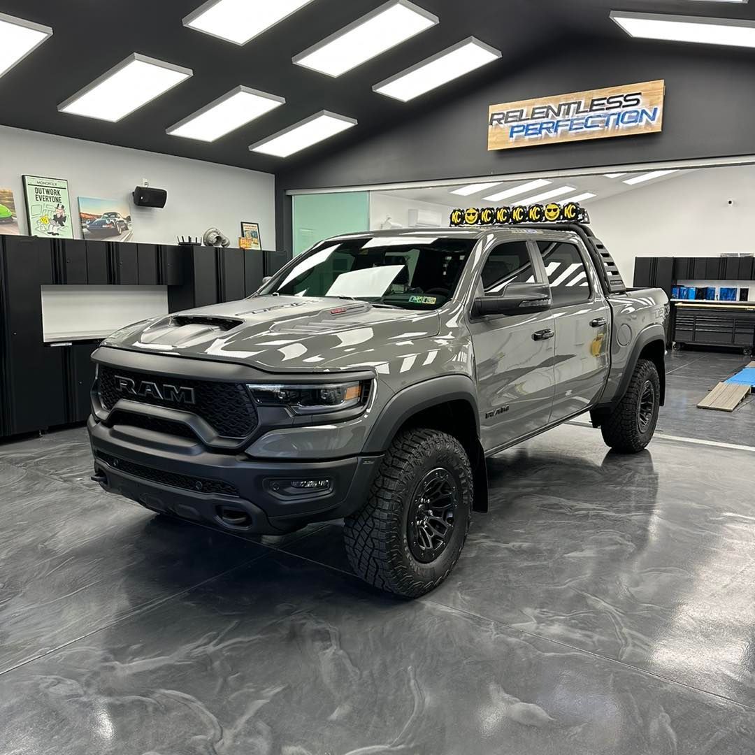 A gray ram truck is parked in a garage.