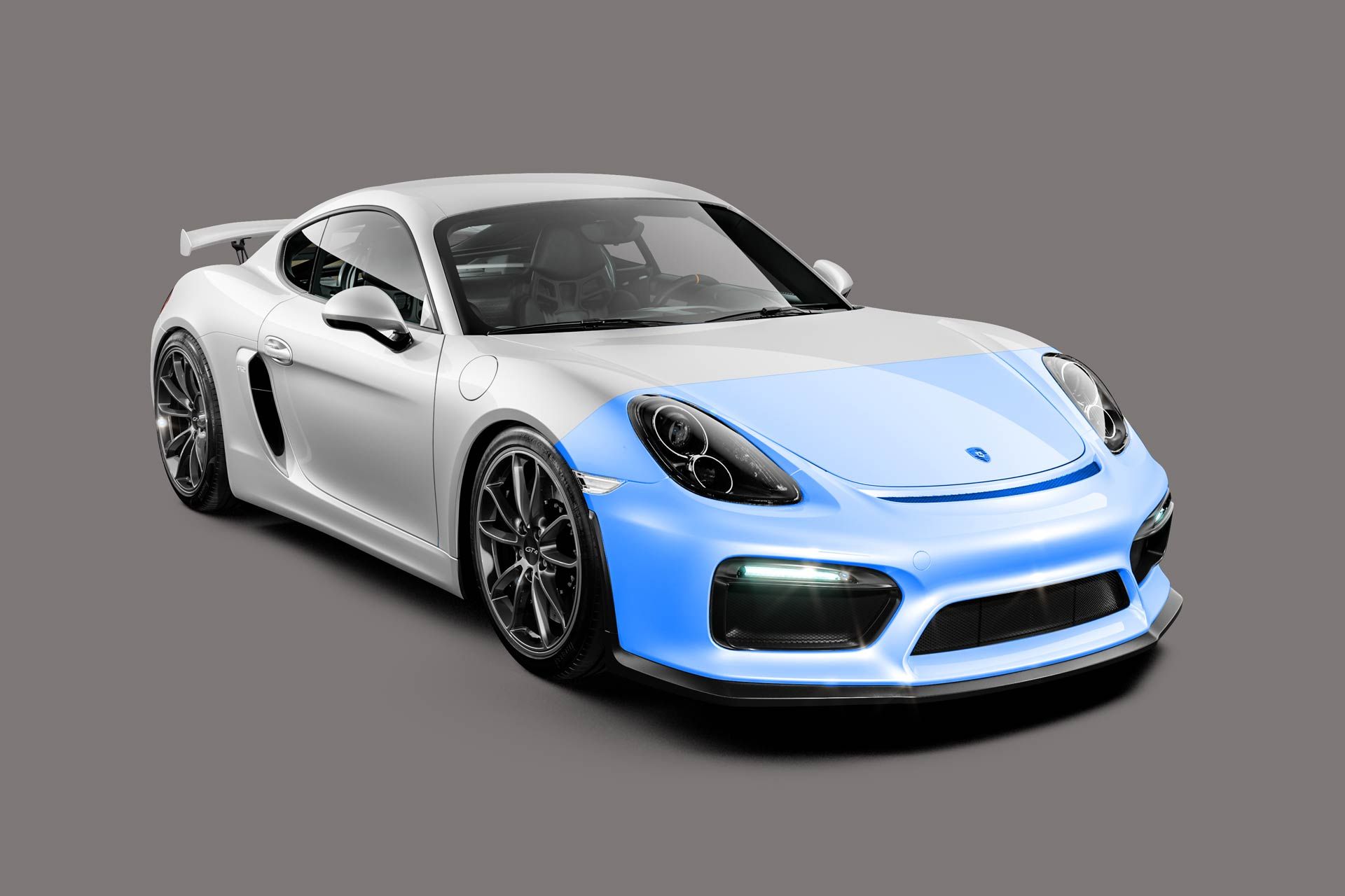 A white porsche 911 gt4 rs with a blue front bumper on a gray background.