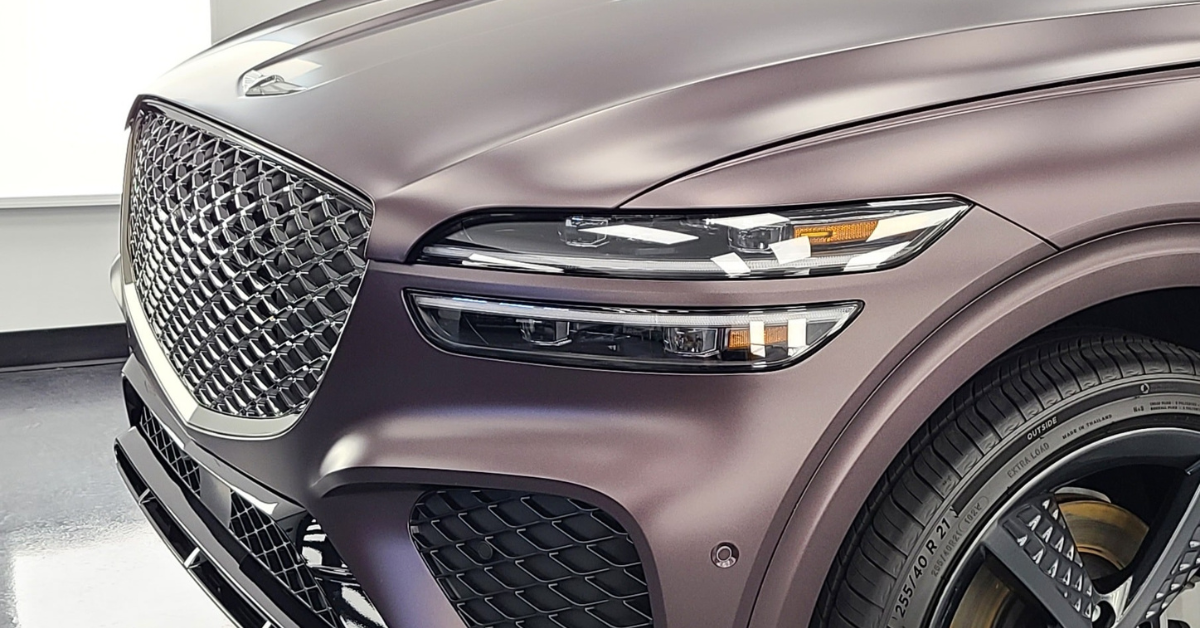 A close up of the front of a purple car