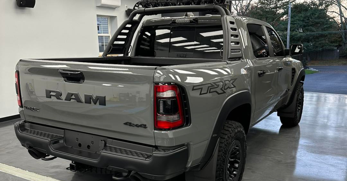 A gray ram truck is parked in a garage.