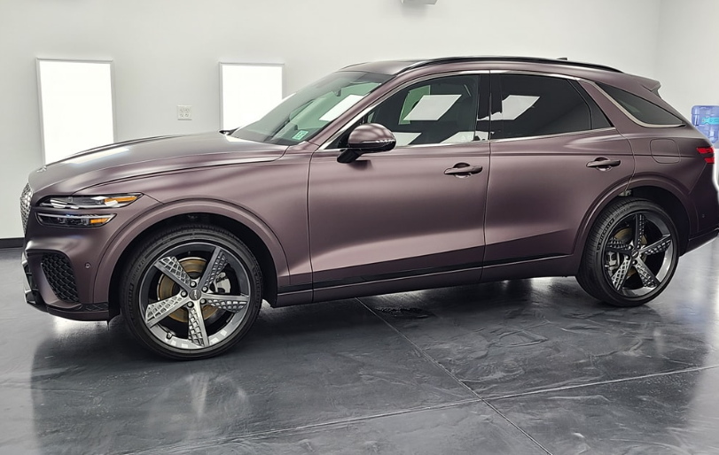 A purple suv is parked in a garage.