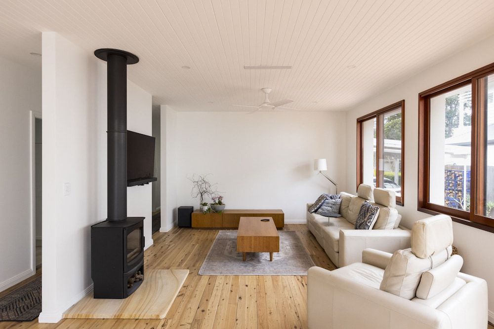 There Is A Fireplace In The Middle Of The Living Room — Matt Loder Constructions in Bulli, NSW
