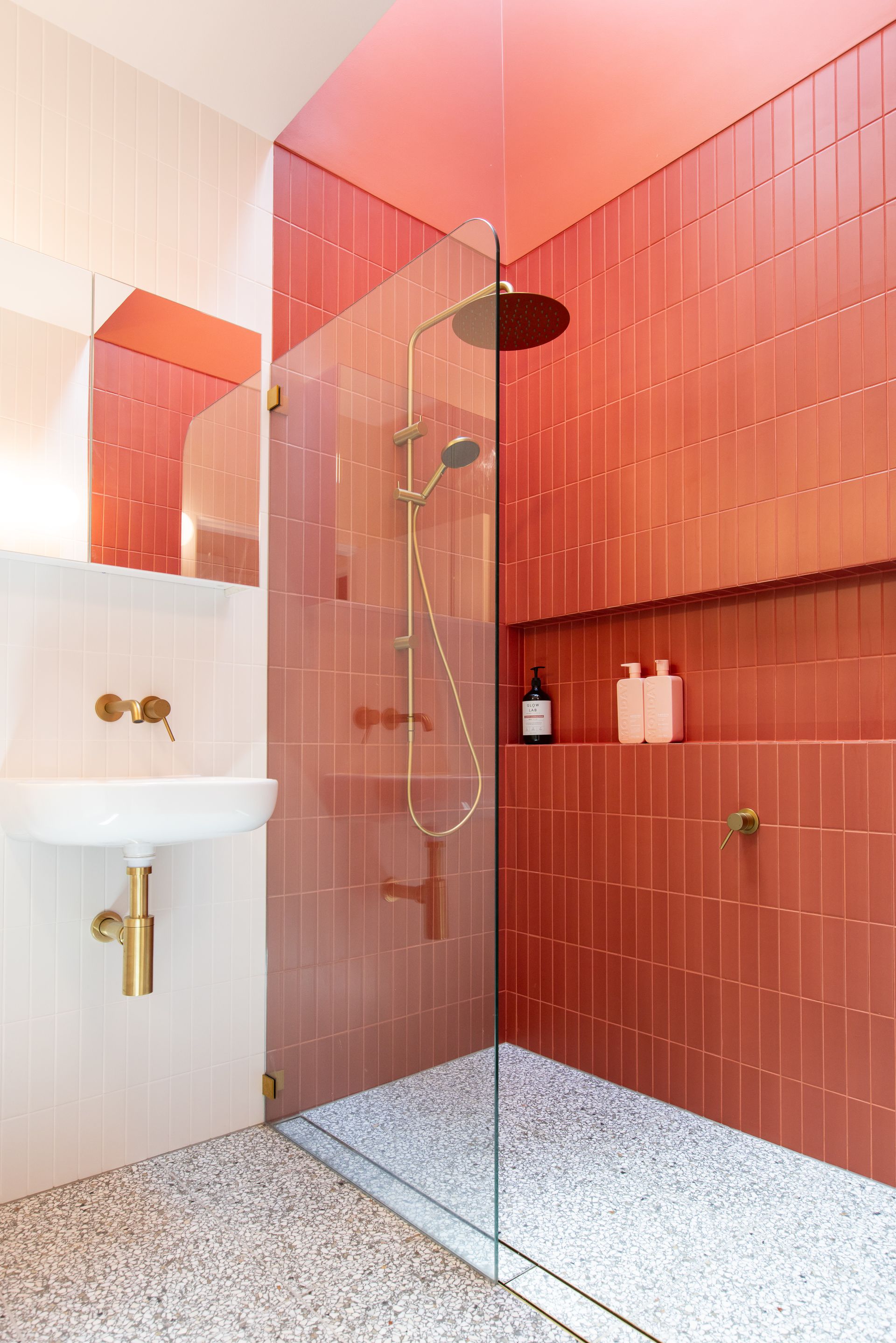 A bathroom with red tiles and a walk in shower. — Matt Loder Constructions in Bulli, NSW
