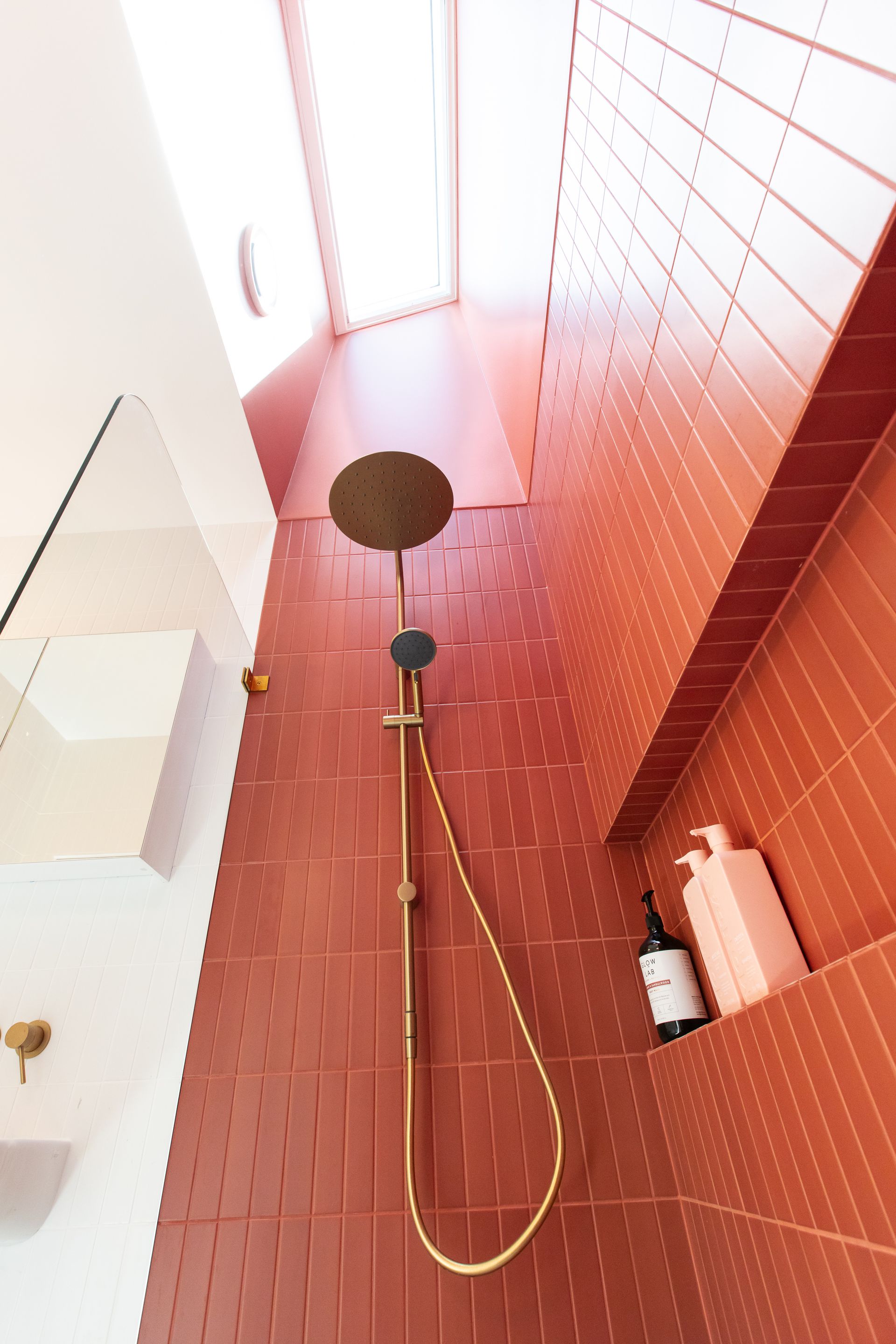 A bathroom with red tiles and a shower head. — Matt Loder Constructions in Illawarra, NSW
