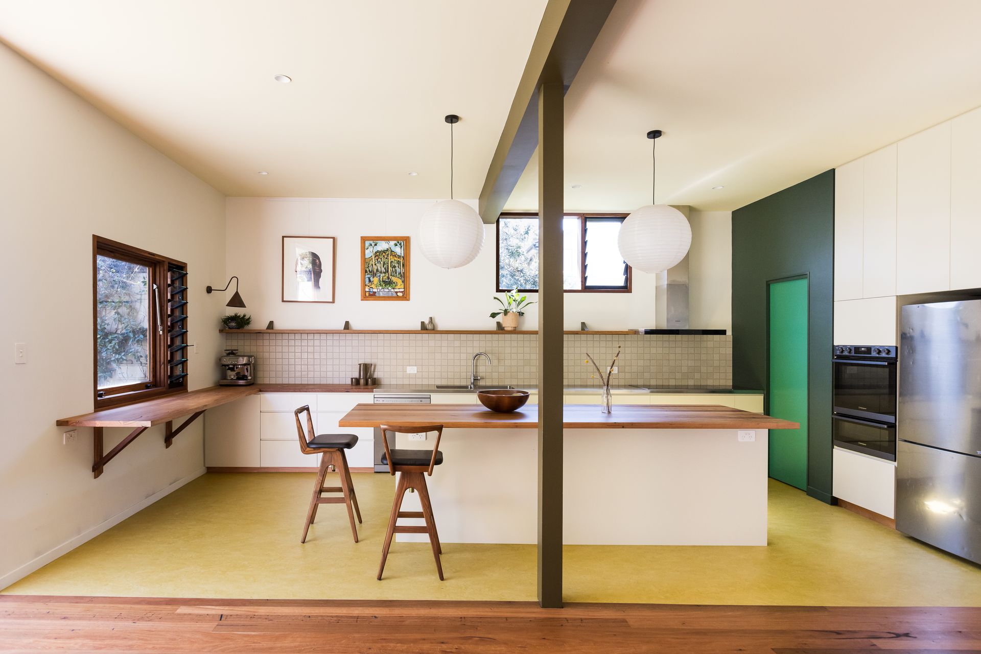 A kitchen with a table and chairs in it — Matt Loder Constructions in Bulli, NSW