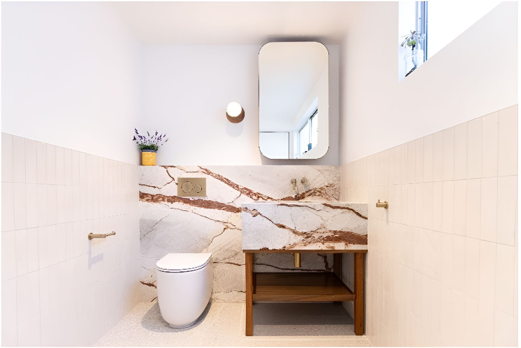 A Bathroom With a Toilet , Sink and Mirror — Matt Loder Constructions in Woonona, NSW