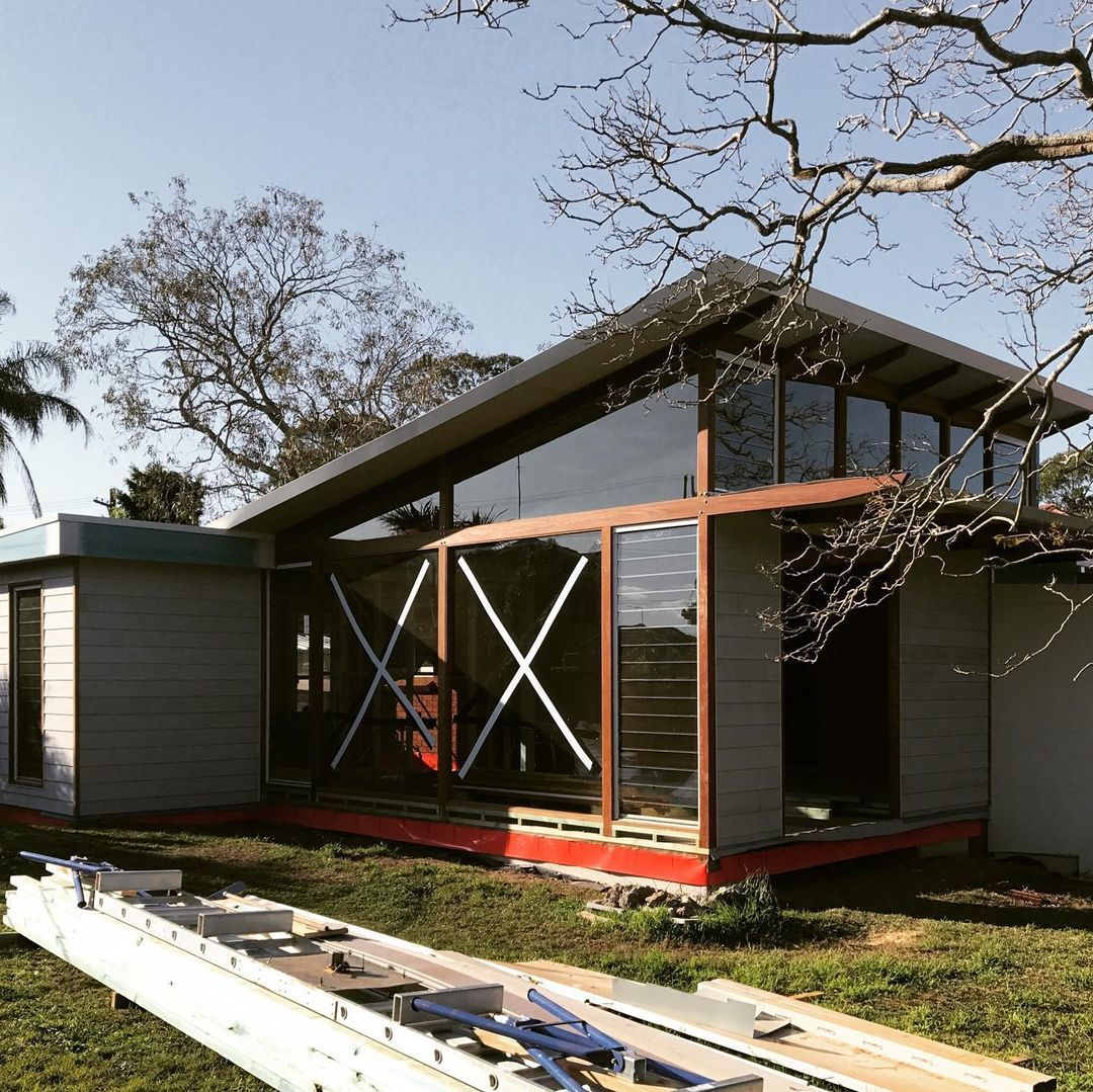 A White House With a Wooden Deck and Stairs — Matt Loder Constructions in Bulli, NSW