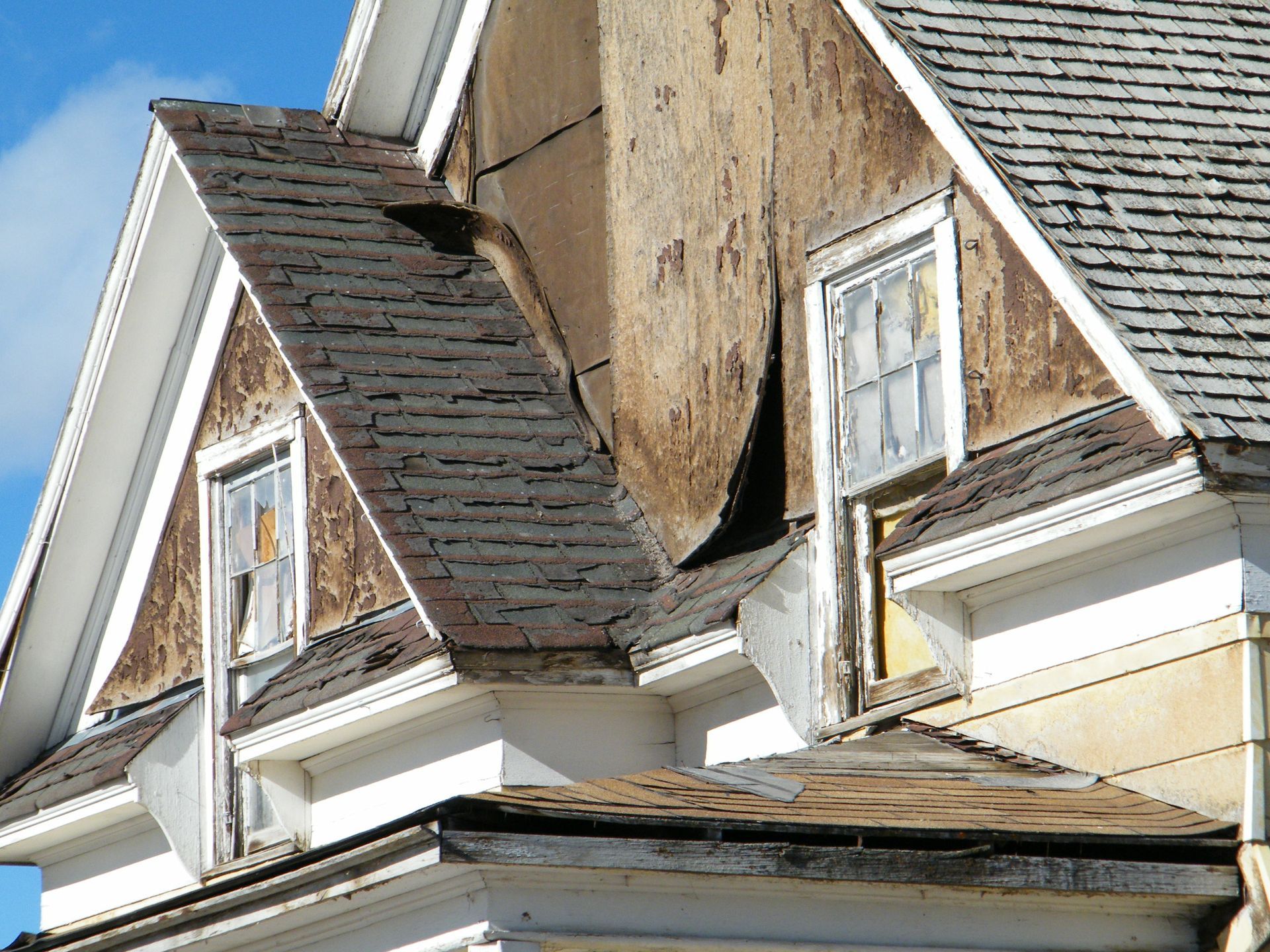 A house with a roof that has a hole in it