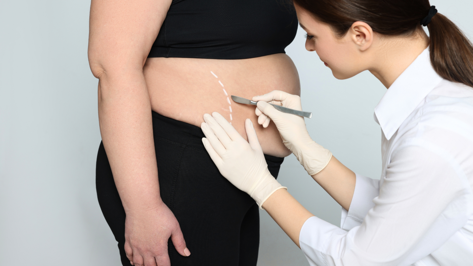 Healthcare worker administering an injection to a patient's abdomen with a syringe