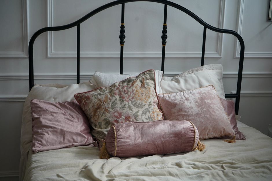 Quarto com cama arrumada e travesseiros, ilustrando o descanso após a cirurgia de hérnia