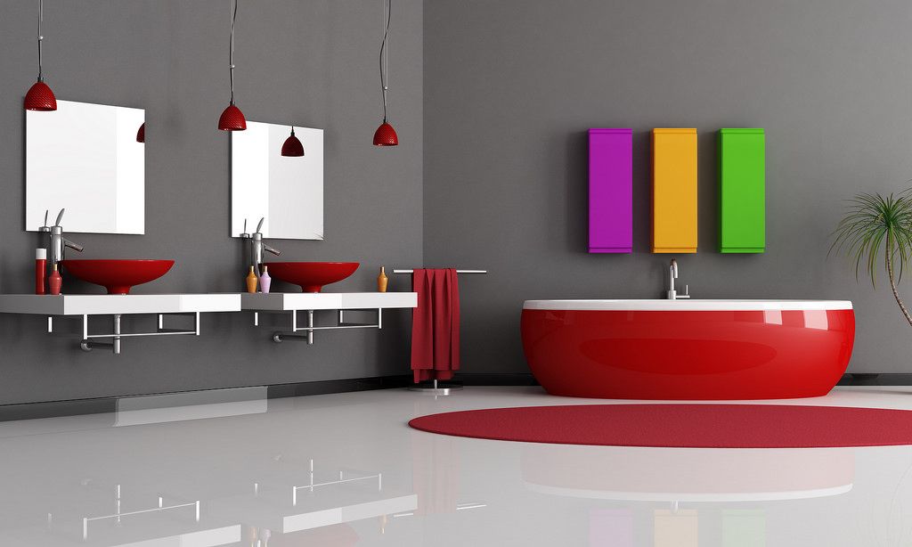 A bathroom with two sinks and a red tub