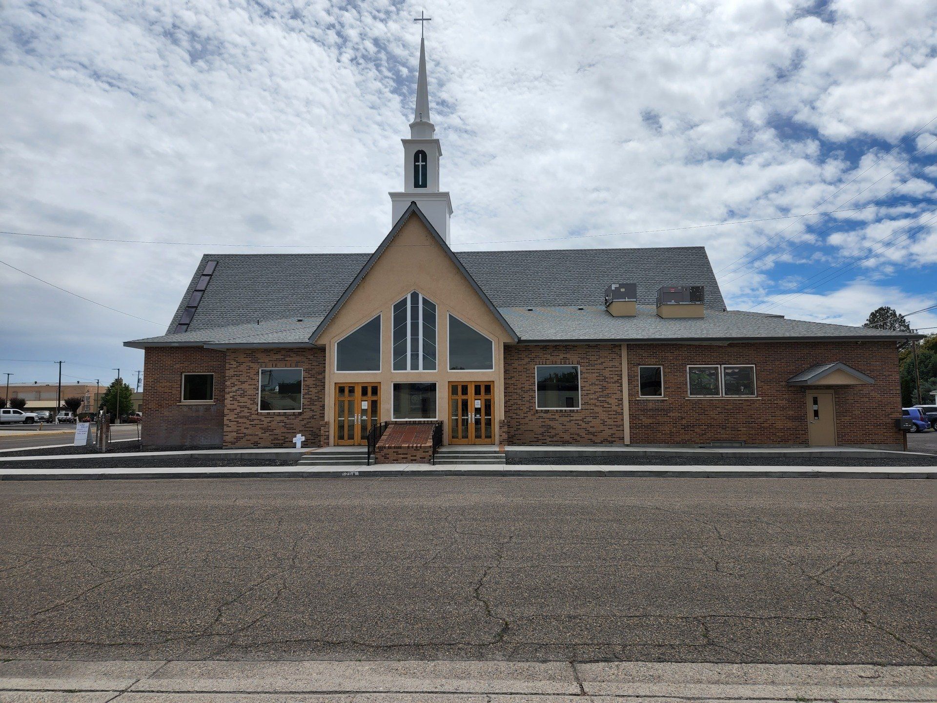 A church with a steeple and a cross on top of it
