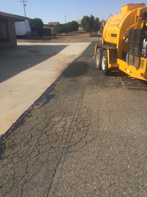 Workers pouring and smoothing wet concrete for a sidewalk.