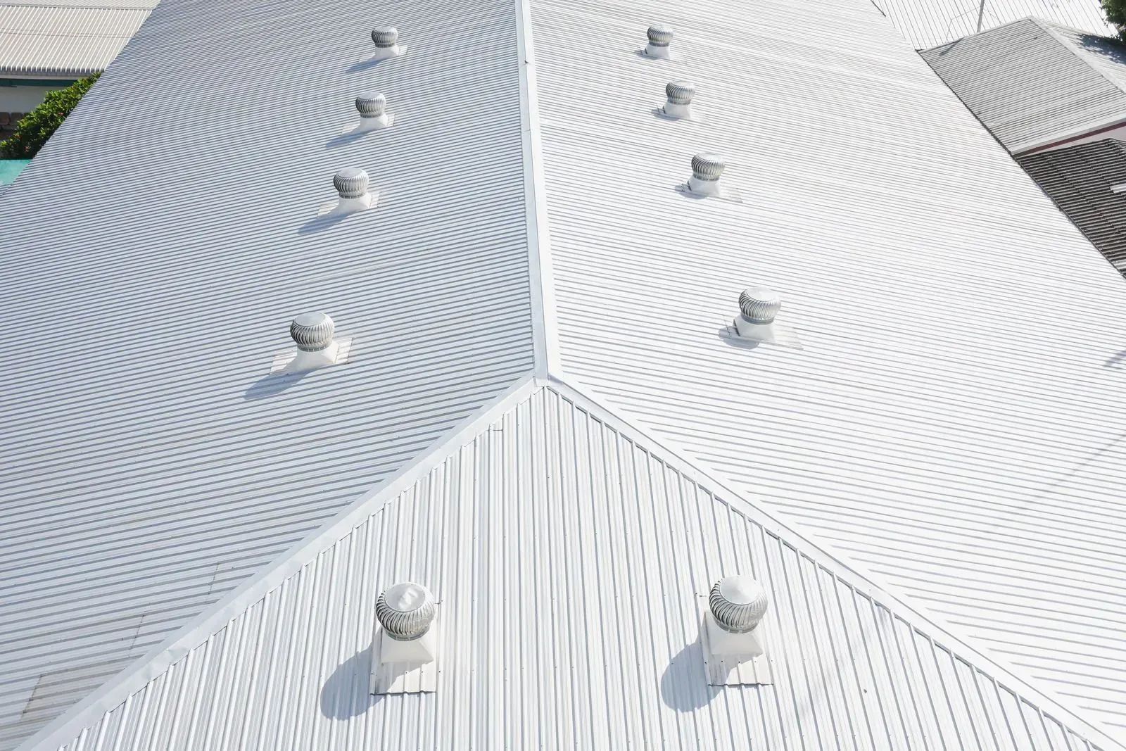 Silver metal roof with circular ventilation domes.