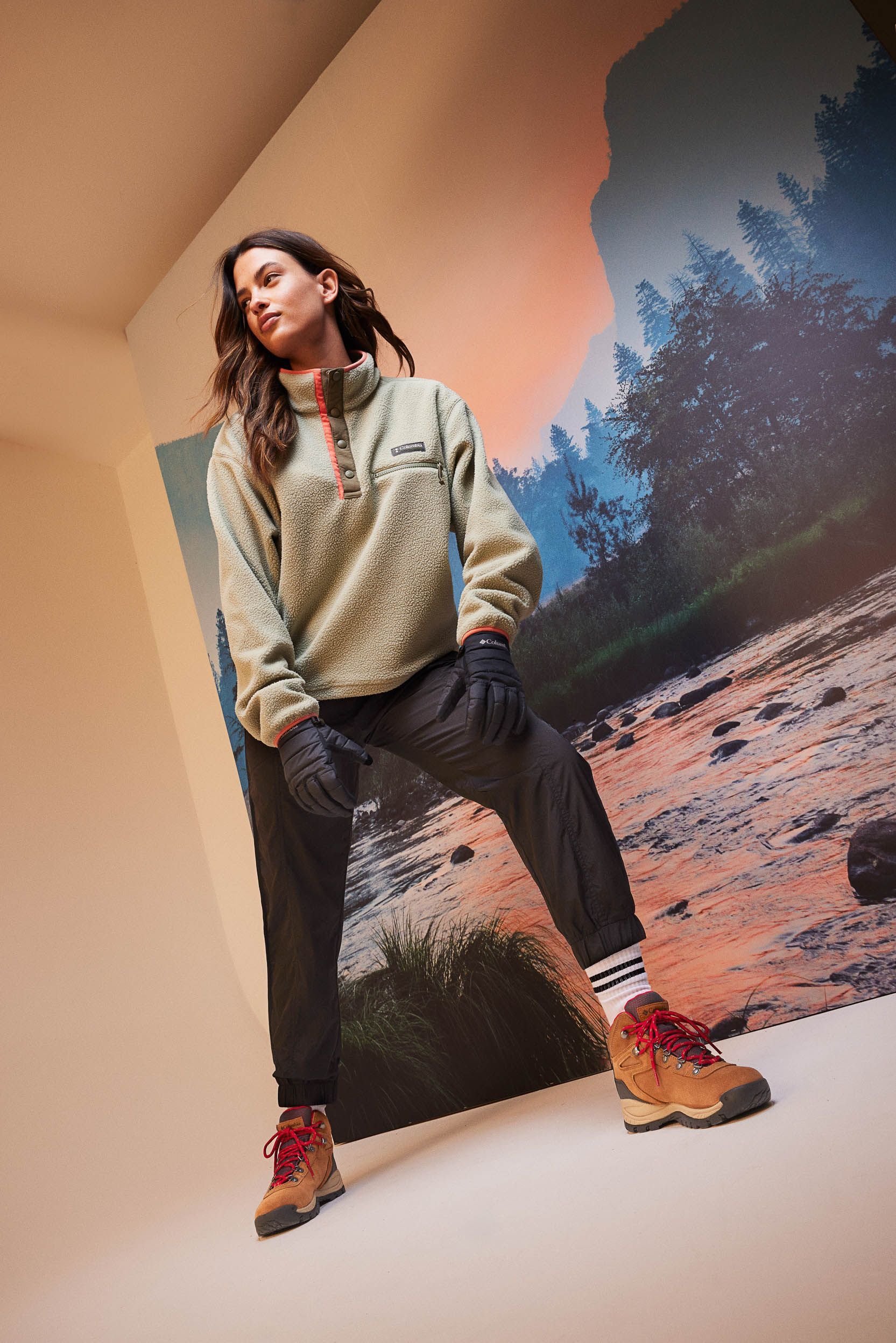 a woman is standing in front of a picture of a river .