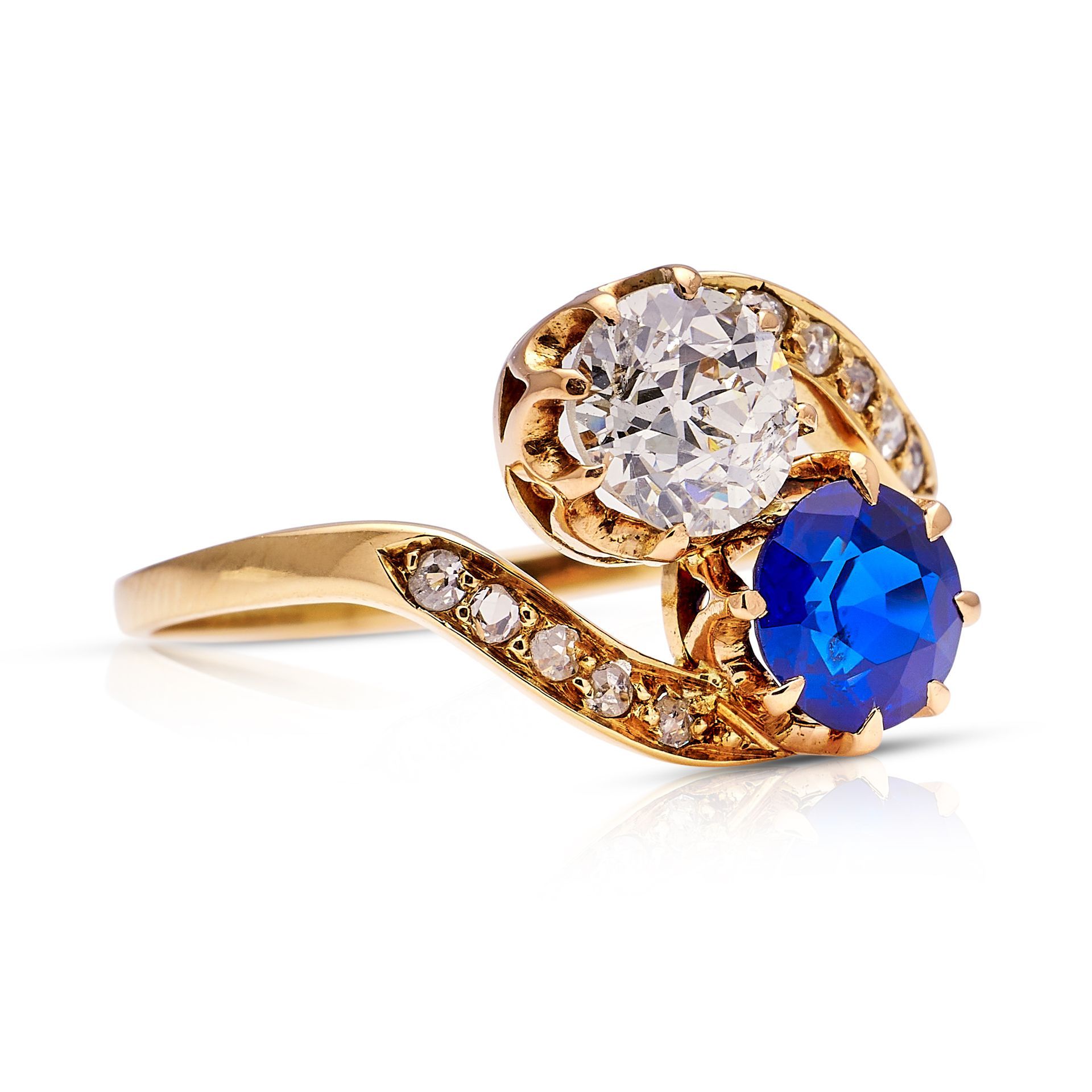 a gold ring with a sapphire and a diamond