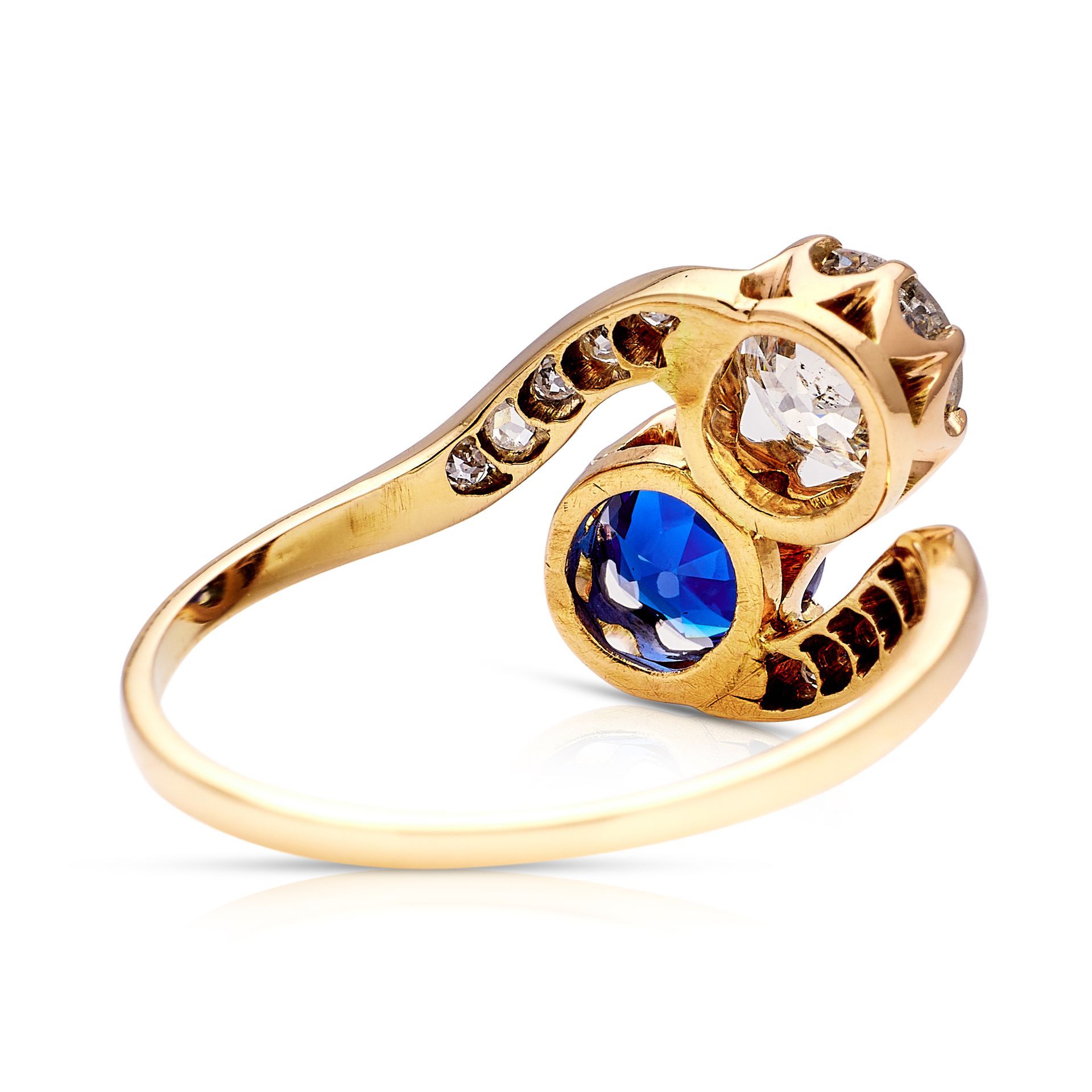 a gold ring with a blue stone and diamonds