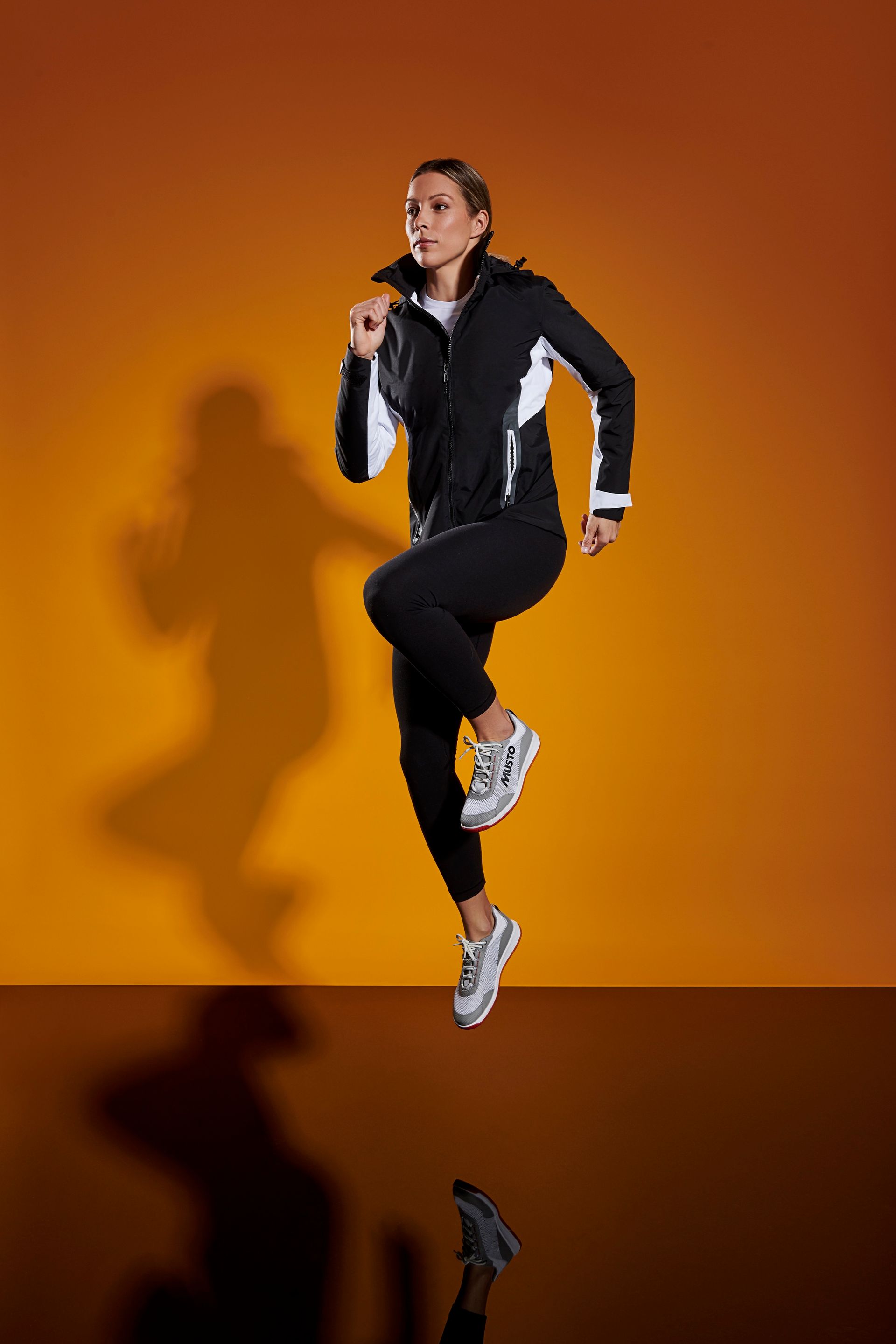 a woman is jumping in the air while running .