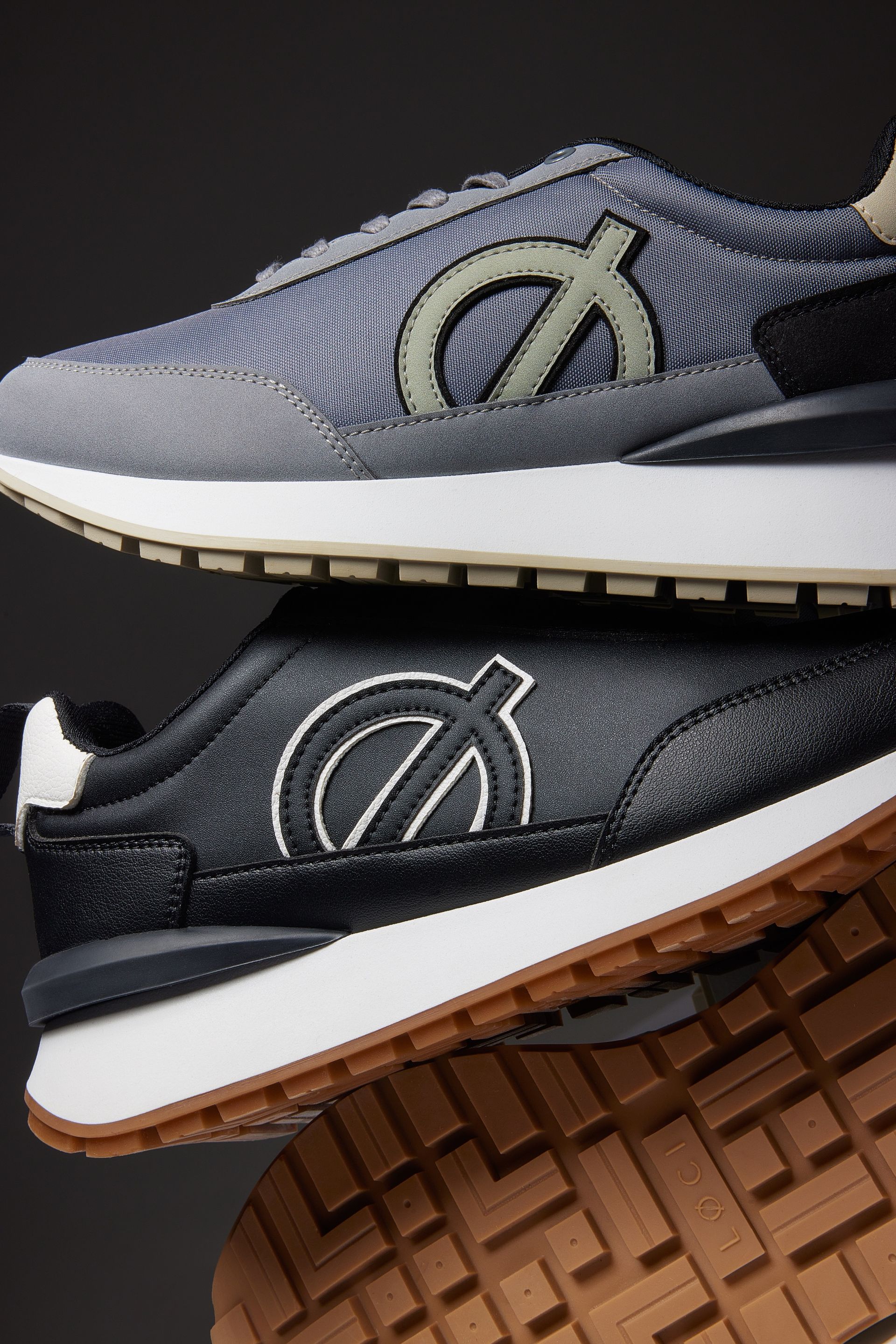 a pair of sneakers are stacked on top of each other .