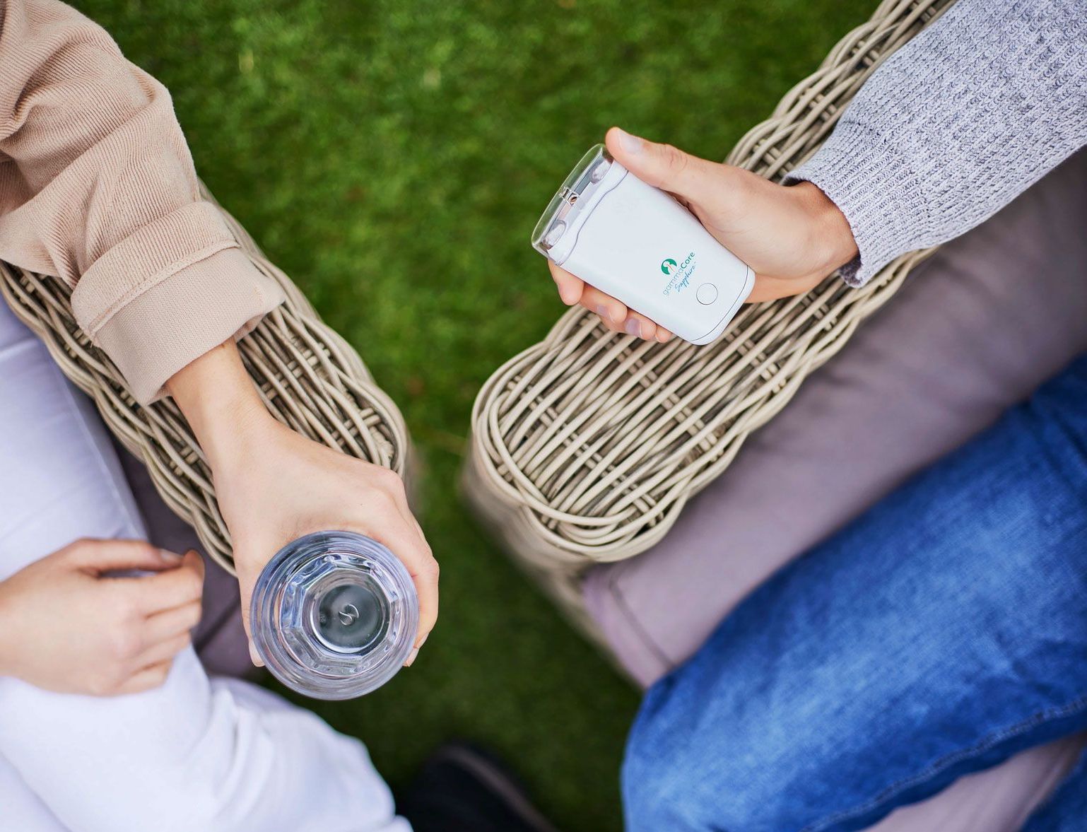 a person is holding a remote control and a bottle of water