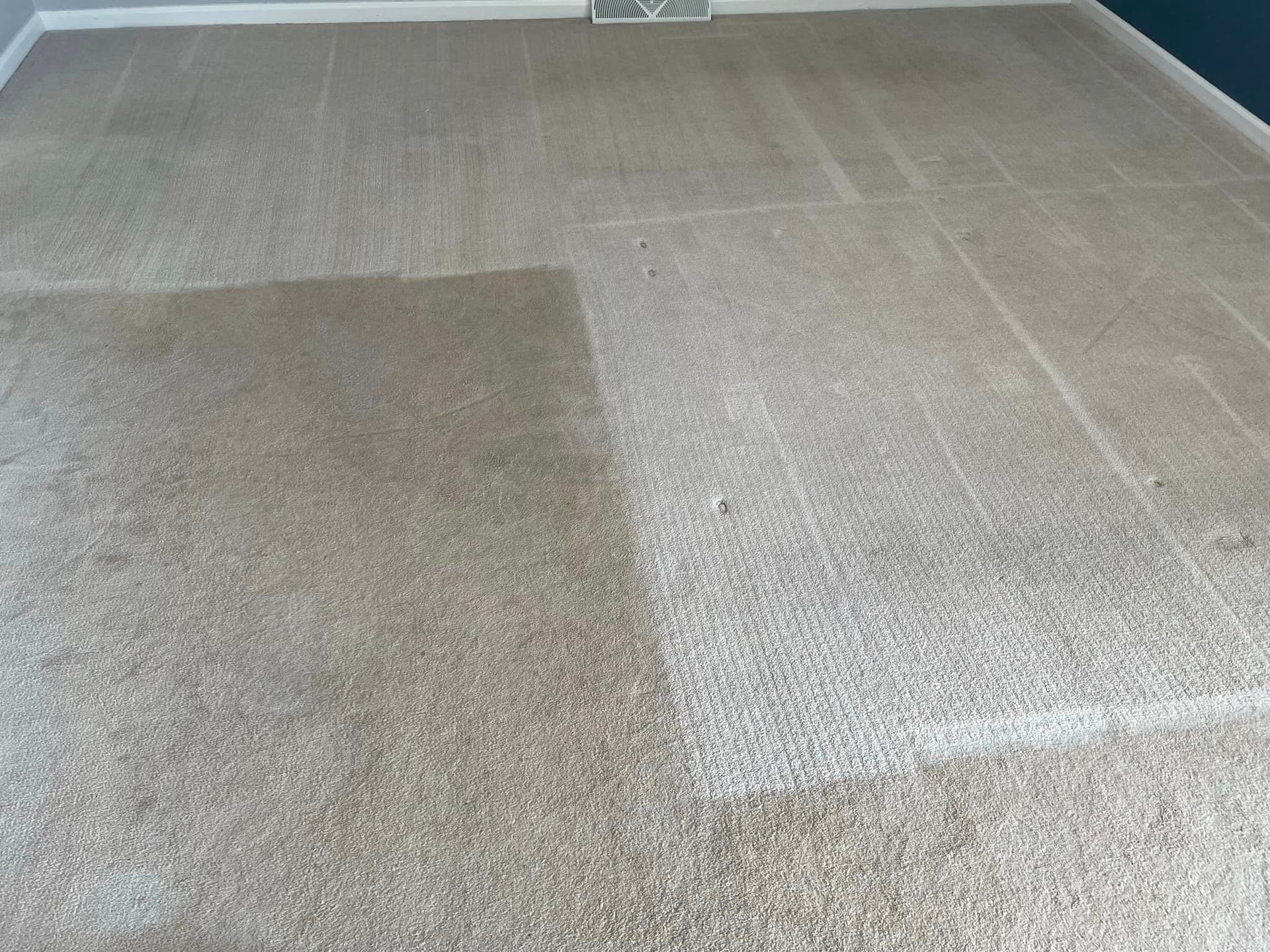 A room with a carpet that is dirty and clean.