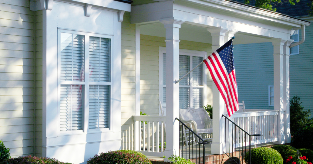 White house porch with American flag.