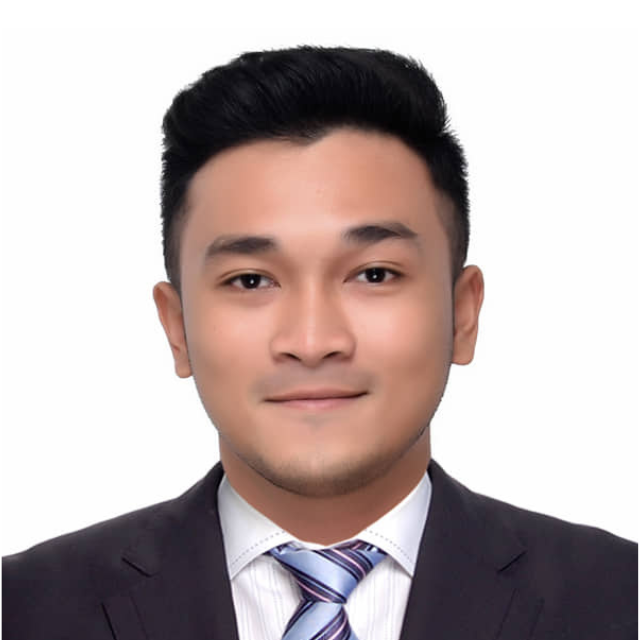Man wearing suit, tie. White backdrop.