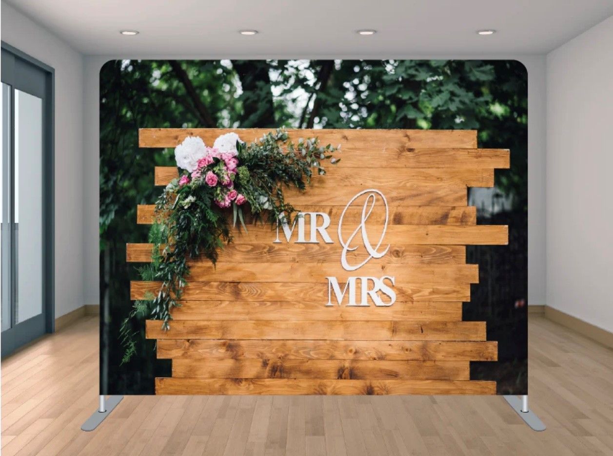 A wooden wall with the words mr and mrs written on it is in a room.