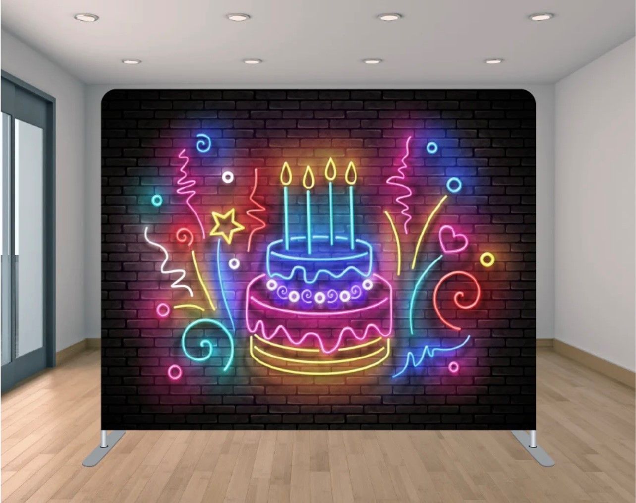 A neon sign of a birthday cake with candles on a brick wall.