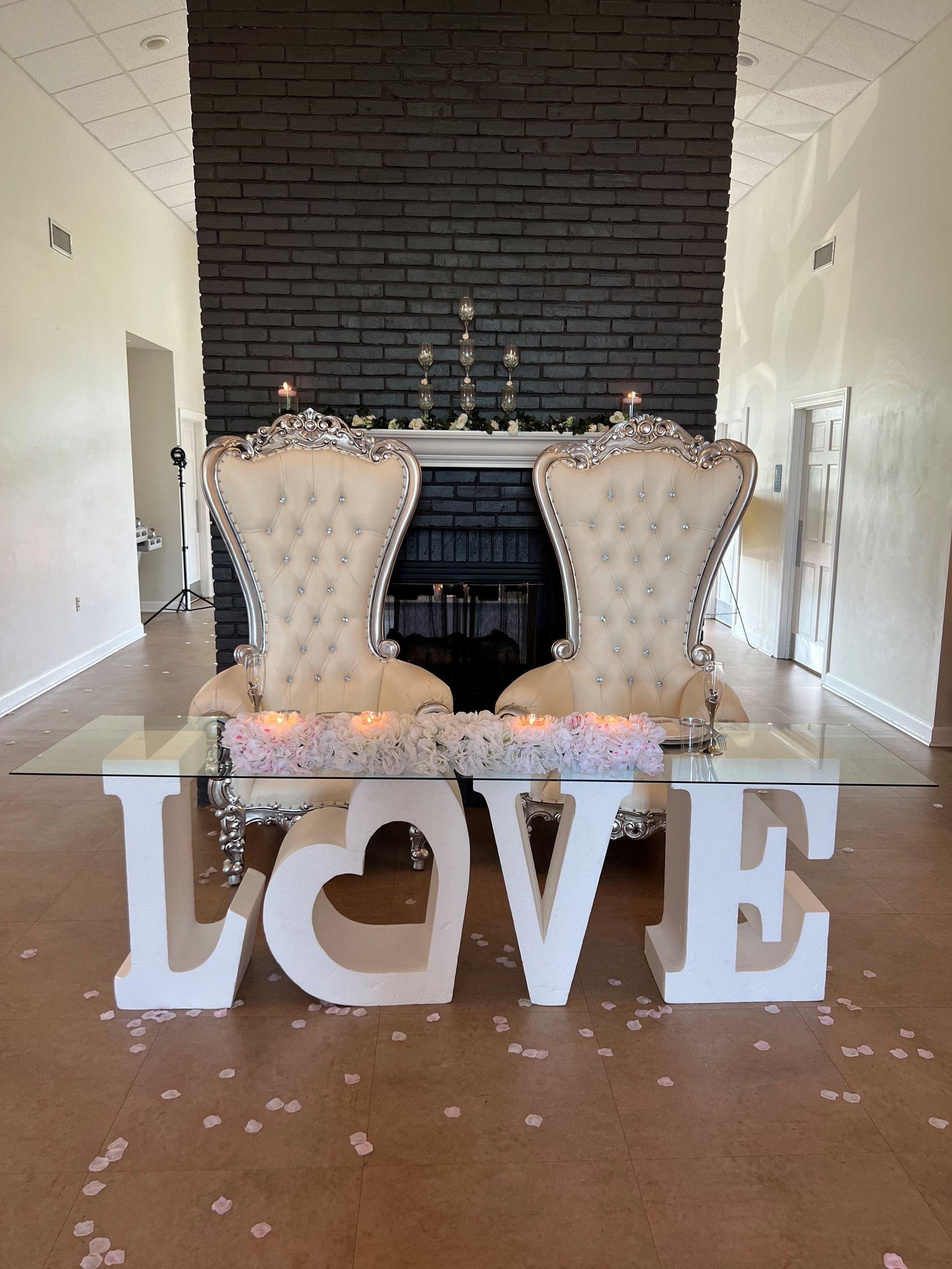 A photo booth is set up in a room with a red carpet and a sign.
