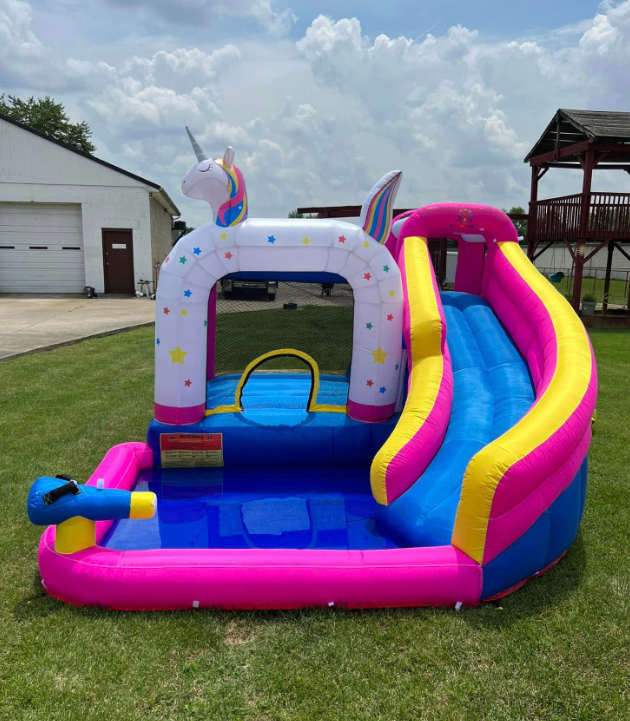 A pink and blue bouncy house with a unicorn on it