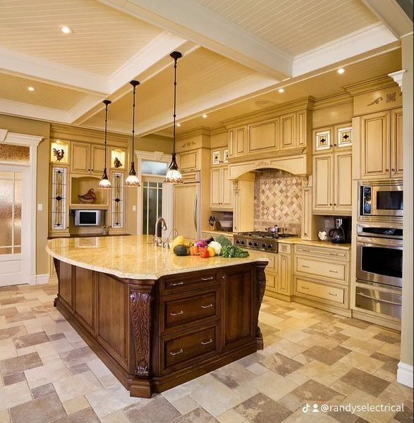 A kitchen with stainless steel appliances and a large island.