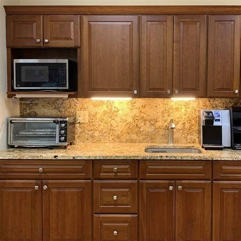 A kitchen with wooden cabinets and granite countertops.