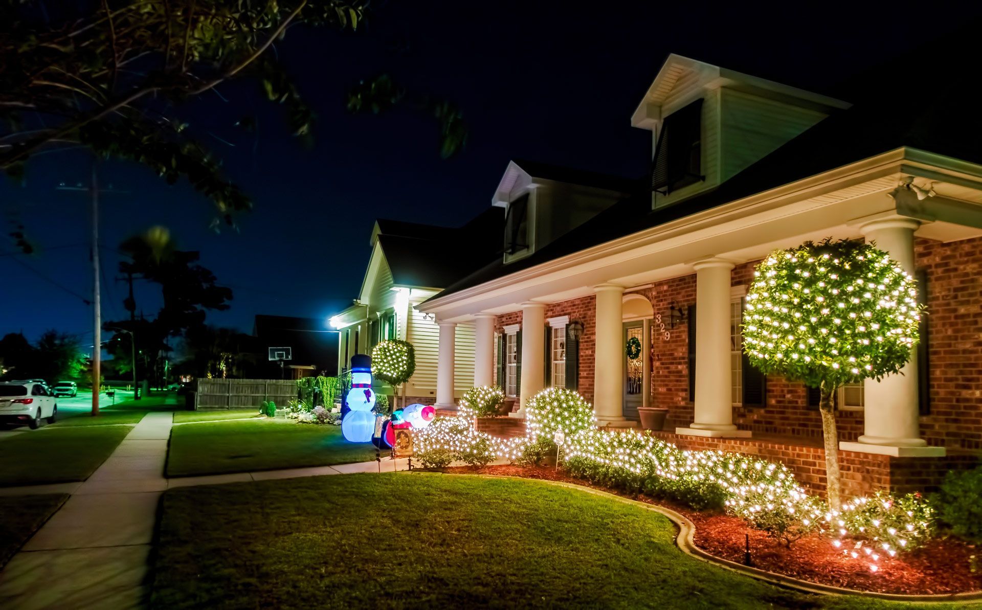 A house is decorated with christmas lights at night