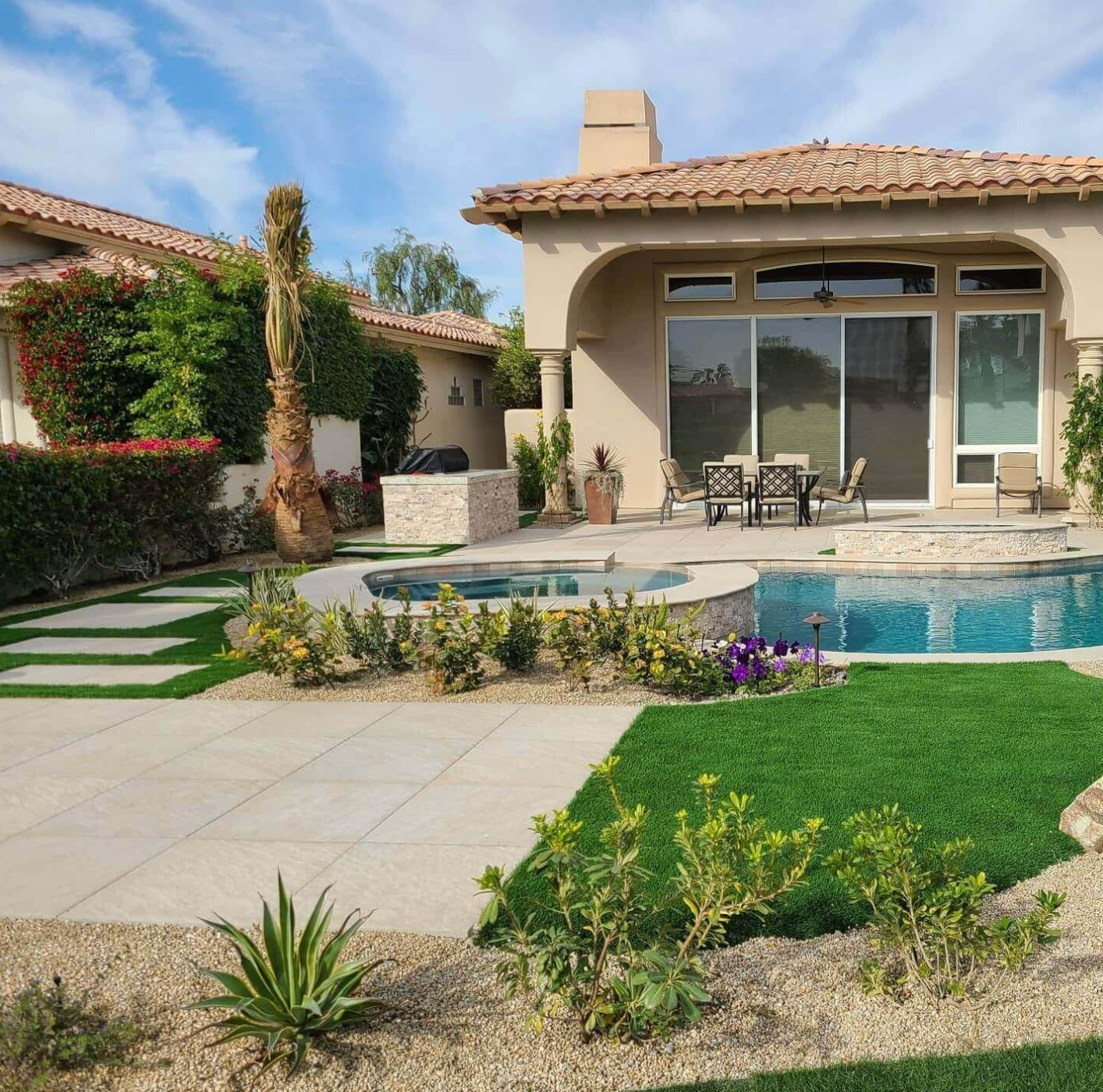 A house with a swimming pool in front of it